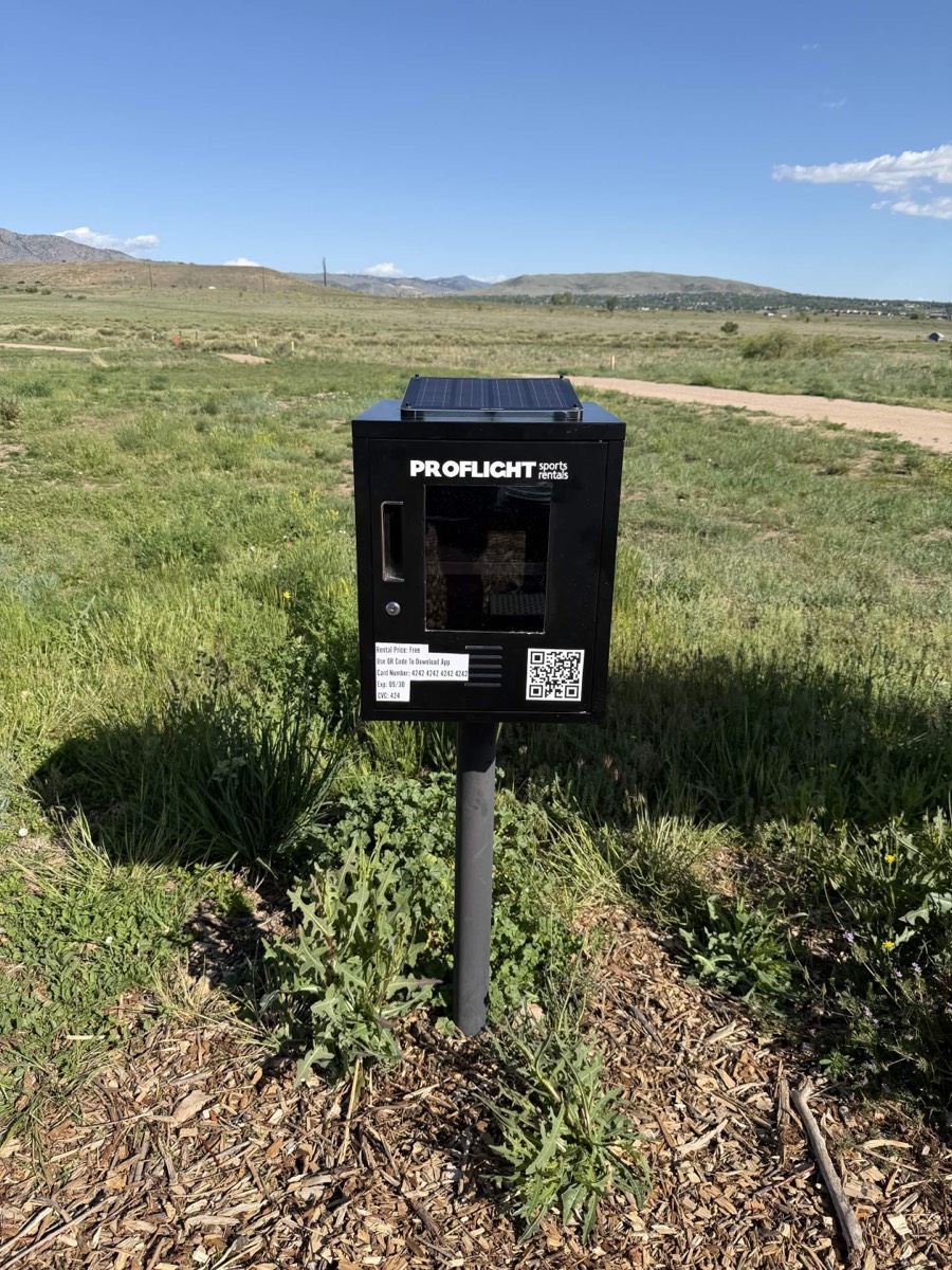 ProFlight sports locker installed on a post at Fehringer Ranch in Morrison, Colorado, with the disc golf field and front-range foothills behind it